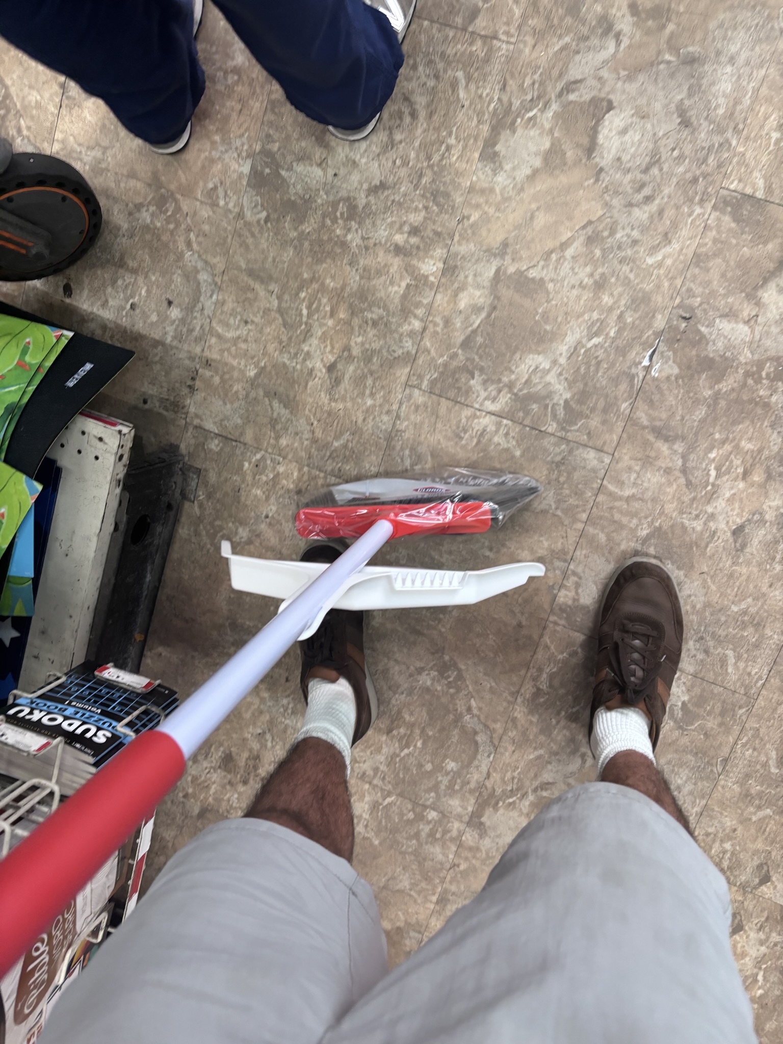 in line at family dollar to purchase a broom